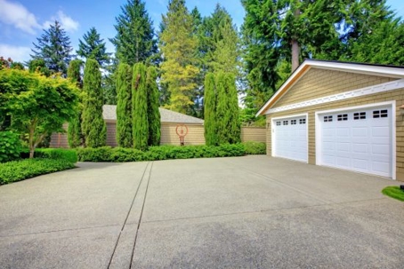 The asphalt driveway in front of a two car garage