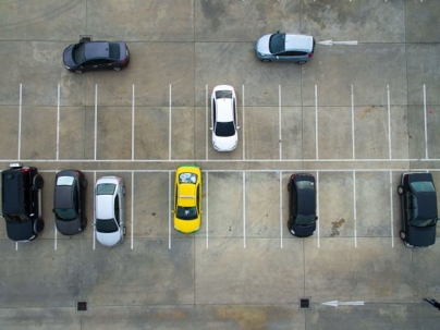 A parking lot with cars in some of the spaces