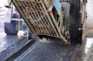An asphalt paver on fresh asphalt