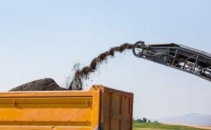 Disposal of asphalt materials into dumpster