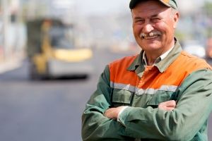 A member of the Mid Atlantic Asphalt team wearing a uniform and smiling at the camera