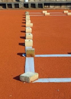 A tennis court being freshly repainted after maintenance